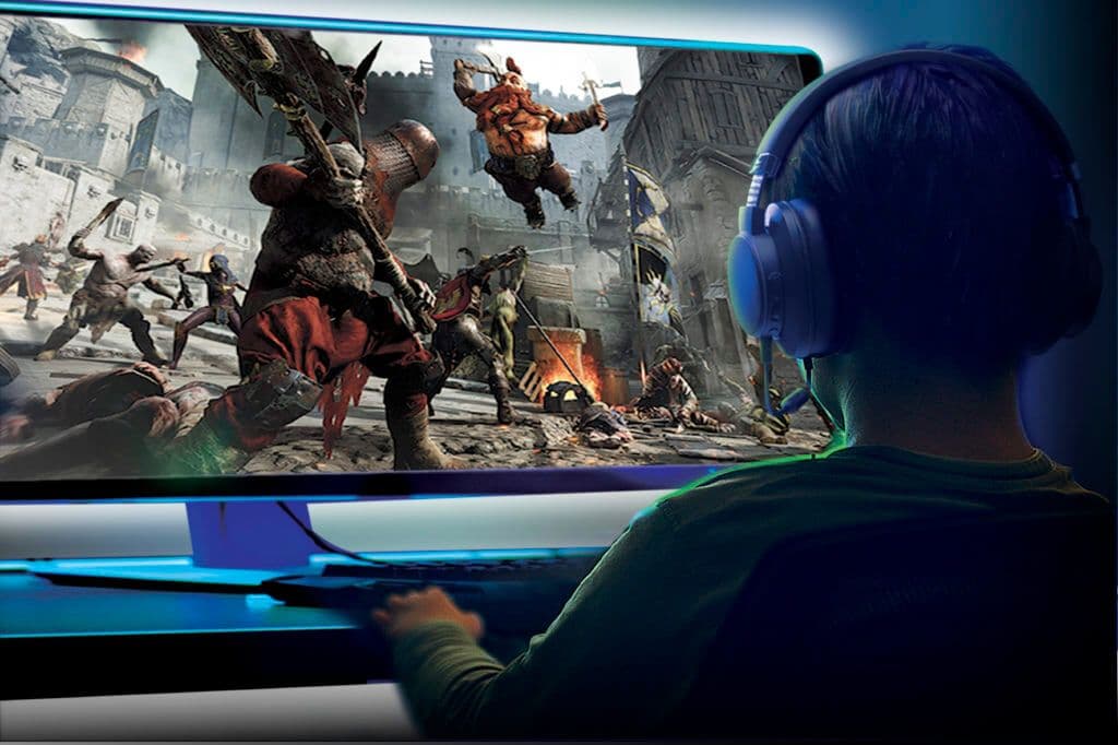 Young Boy Playing Games On A Computer At Home